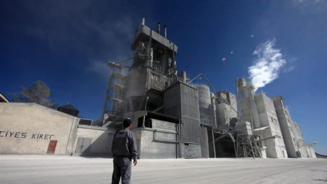 Worker near large industrial kilns